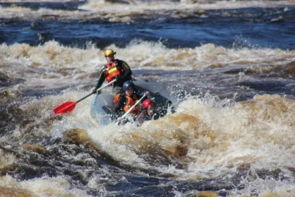 paddlers in an boat in the rapids.