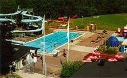 Swiming pool, water slides, grass surfaces.