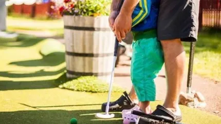Father and son golfing together.