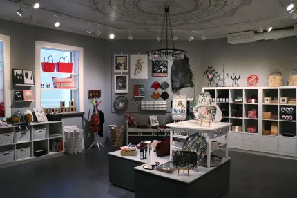 Interior image rom the shop, different products on shelves and on a table.
