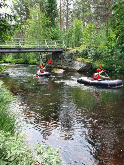 Two pack rafters in a stream.