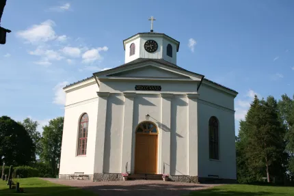A white octagonal building with a small tower.